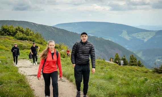People hiking on a mountain trail with scenic views